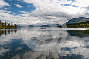 Great beautiful lake TornetrÃ¤sk, which reflects the surrounding mountains and clouds. Lezero is located in the Abisko Park