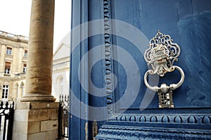 Great blue door with ornamental knocker at the City Hall of Bordeaux, France