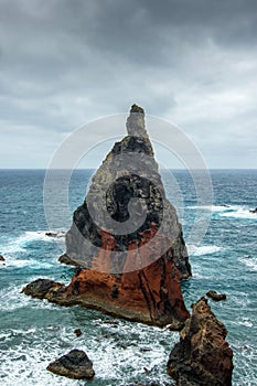 Great boulder in the atlantic ocean at the shore of the peninsula Ponta do Sao Lourenco, dramatic sky