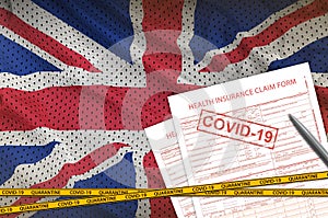 Great britain flag and Health insurance claim form with covid-19 stamp. Coronavirus or 2019-nCov virus concept