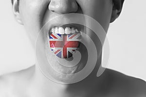 Great Britain flag painted in tongue of a man - indicating English language and British accent speaking in Black and White tone