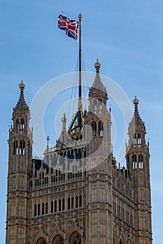Great Britain flag on top of the Palace of Westminster known as Houses of Parliament, London, UK