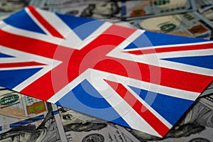 Great Britain flag with US dollars as background. Concept for investors, soft focus