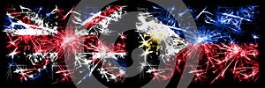 Great Britain, United Kingdom vs Philippines, Filipino New Year celebration travel sparkling fireworks flags concept background.