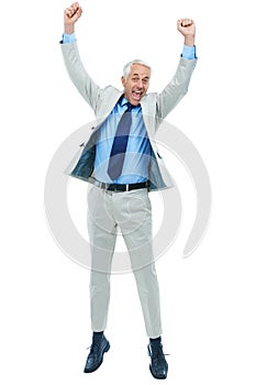 Great business success. Full length studio shot of a mature businessman jumping for joy isolated on white.