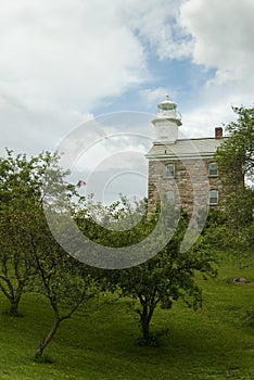 Great Captain Island Lighthouse As Sun Breaks Among Storm Clouds Approaching