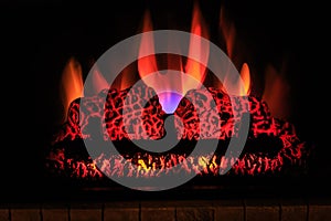 great closeup view of indoor fireplace with flame on dark, halloween background