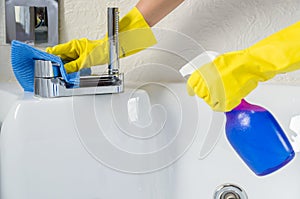 Great concept of domestic cleaning, hand with glove cleaning bath