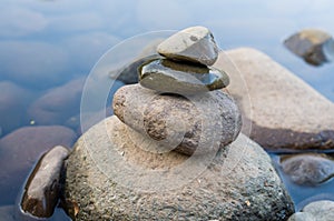 Great concept of spiruality, tranquility and meditation, land art with stones in waterfall