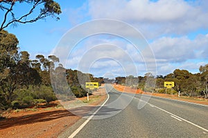 Great Eastern Highway in Western Australia with road train entering signs