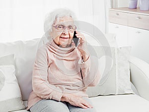 Great-grandmother talking by smartphone