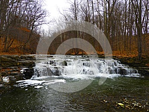 Great Gully Creek waterfall in woods during late winter photo