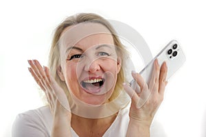 great happiness success joy close-up face of a woman laughing sincerely open her mouth looks to the side holds the phone