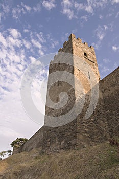 Great historical brick tower under cloudy summer sky