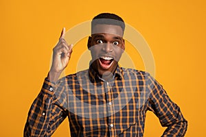 Great Idea. Excited African Guy Pointing Finger Up And Looking At Camera