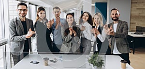 Great job! Successful business team is clapping their hands in modern workstation, celebrating the performance of new product