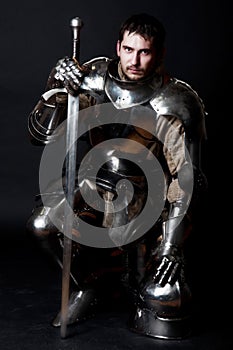 Great knight holding his sword and helmet