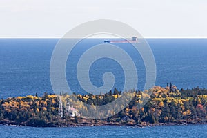 Great Lakes Oar Boat Passing Behind a Lighthouse