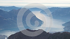 Great landscape at Iseo lake in winter season, foggy and humidity in the air. Panorama from Monte Pora, Alps, Italy