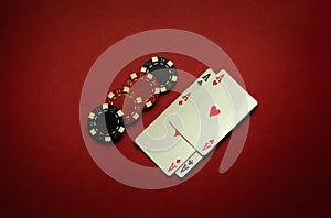 Great luck in the card game of poker with a winning combination of four of a kind or quads. Playing cards aces and chips are laid