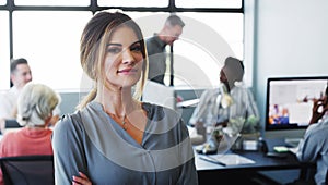 Great managers keep their teams focused on the company mission. Portrait of a confident young businesswoman working in a