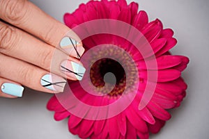 Great manicure with flower in beauty salon, close up
