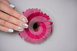 Great manicure with flower in beauty salon, close up