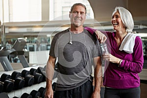 Great marriages start with great fitness. a senior married couple laughing and taking a break from their workout at the