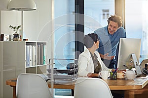 Great minds at work. businesspeople working on a computer in an office.