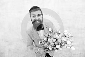 In great mood. bride groom at wedding party. bearded man in bow tie with tulip flowers. love date with flowers. Happy
