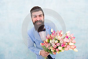 In great mood. bride groom at wedding party. bearded man in bow tie with tulip flowers. love date with flowers. Happy