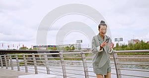 Great news - Caucasian woman with a smartphone in her hand is jumping with happiness.