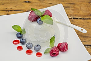 Great panacotta dessert with raspberries and blueberries