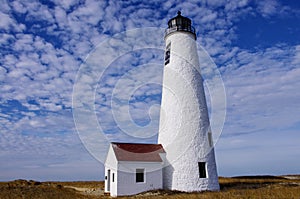 Great Point Lighthouse with blue skies and puffy white clouds, Nantucket, Massachusetts