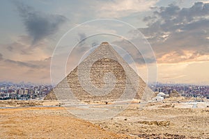 The great pyramid of Cheops in Cairo. The Egyptian pyramids of Giza on the background of Cairo. Miracle of light. Architectural