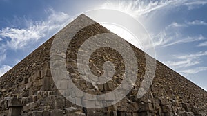 The Great Pyramid of Cheops in Giza. A triangular peak on a background of blue sky