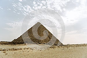 The great pyramid of Mikerina in Cairo, Egypt. Pyramids of Menkaura against blue cloudy sky