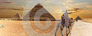 The Great Pyramids of Giza and a bedouin, desert panorama
