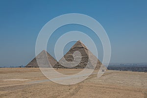 The Great Pyramids of Giza near the ruins of a temple in Giza, Egypt