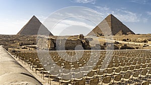 The Great Pyramids of Giza and the Sphinx against the blue sky.