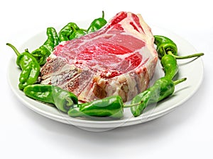 Great raw cutlet of cow with green peppers. photo
