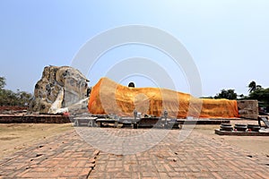 The great reclining Buddha with a bright orange sash is all that remains of Wat Lokaya Sutha. Ayutthaya, Thailand