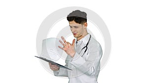 Great results Doctor dancing afler looking through documents on white background.