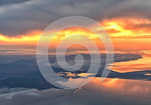 Great Salt Lake Sunset Aerial view from airplane in Wasatch Rocky Mountain Range, sweeping cloudscape and landscape Utah