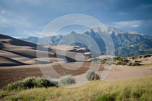 Great Sand Dunes National Park, Colorado, USA. Beautiful scenic majestic sand dunes and mountain peaks. Travel destination locatio