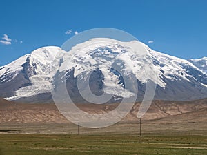 Great snow-capped mountain peak of Mount Muztag Ata on the Pamirs Plateau