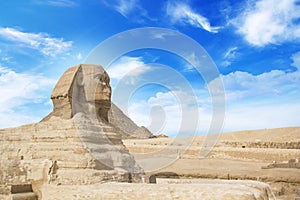 Great Sphinx against the background of the pyramids of the pharaohs Cheops, Khafren, and Mikerin in Giza