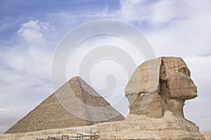 Great Sphinx against the background of the pyramids of the pharaohs Cheops, Khafren, and Mikerin in Giza