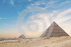 Great Sphinx against the background of the pyramids of the pharaohs Cheops, Khafren, and Mikerin in Giza