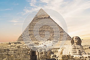 Great Sphinx against the background of the pyramids of the pharaohs Cheops, Khafren, and Mikerin in Giza